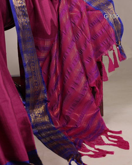 Red and blue patterned fabric with tassels on a plain background