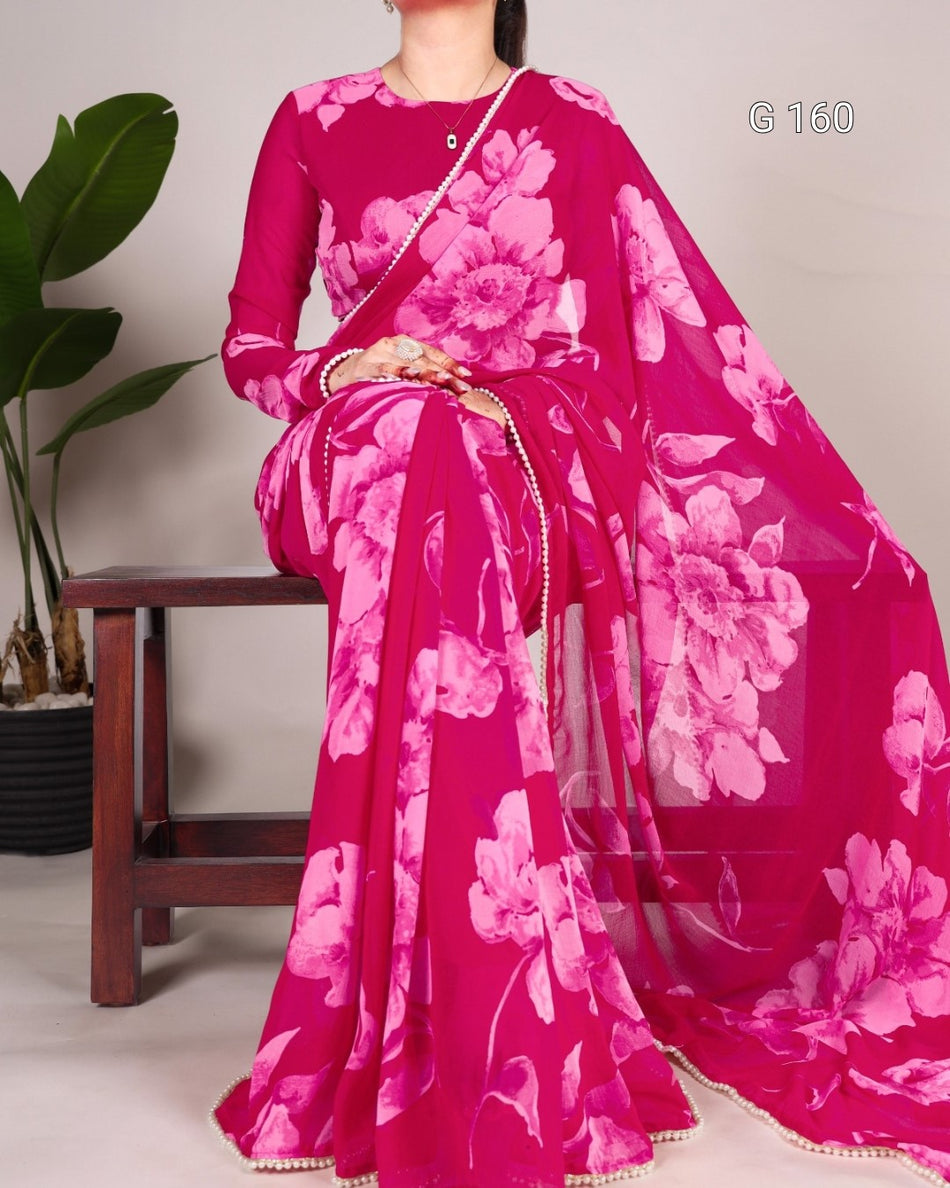 Person wearing a pink floral saree with a white background