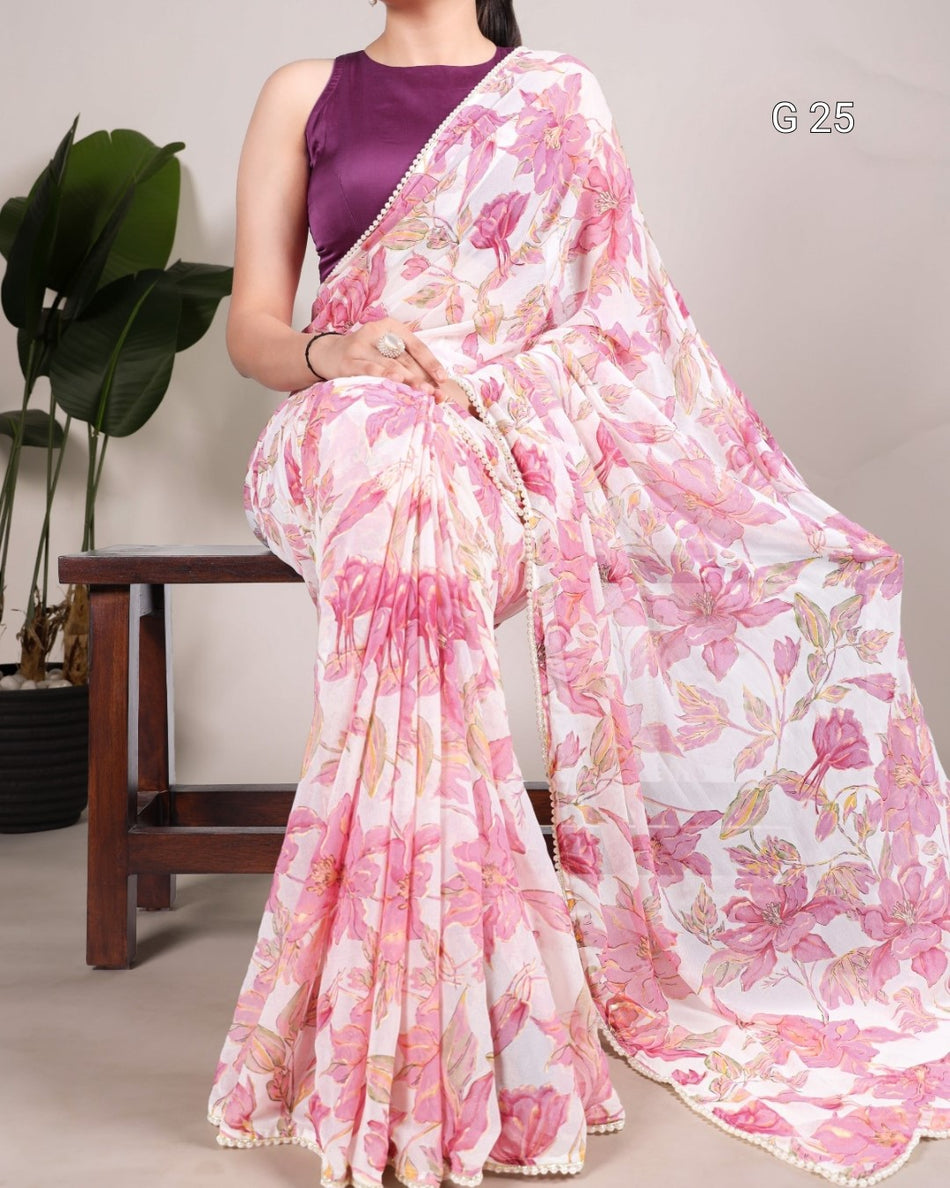 Woman wearing a pink floral saree with a plain background