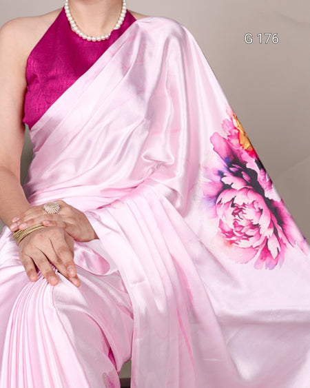 Pink saree with floral design and pink blouse on a neutral background
