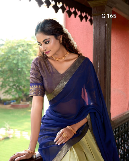 Woman wearing a blue saree with a green background