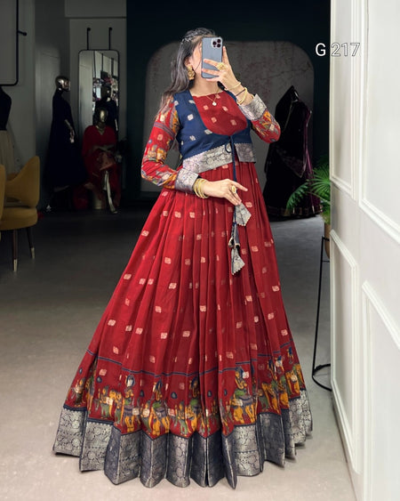 Woman taking a mirror selfie wearing a red and patterned dress in a room.