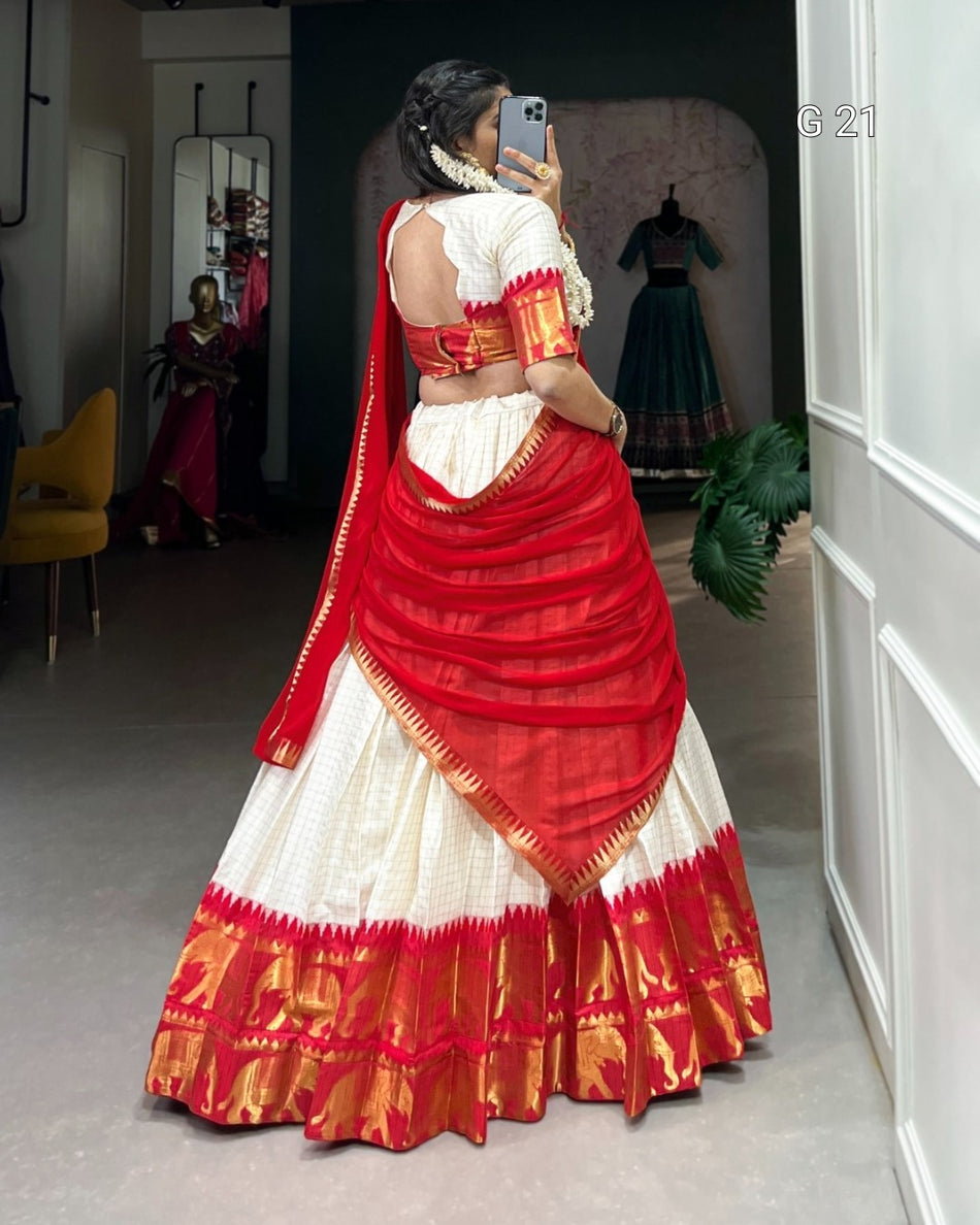 Person wearing a red and white traditional outfit taking a mirror selfie.