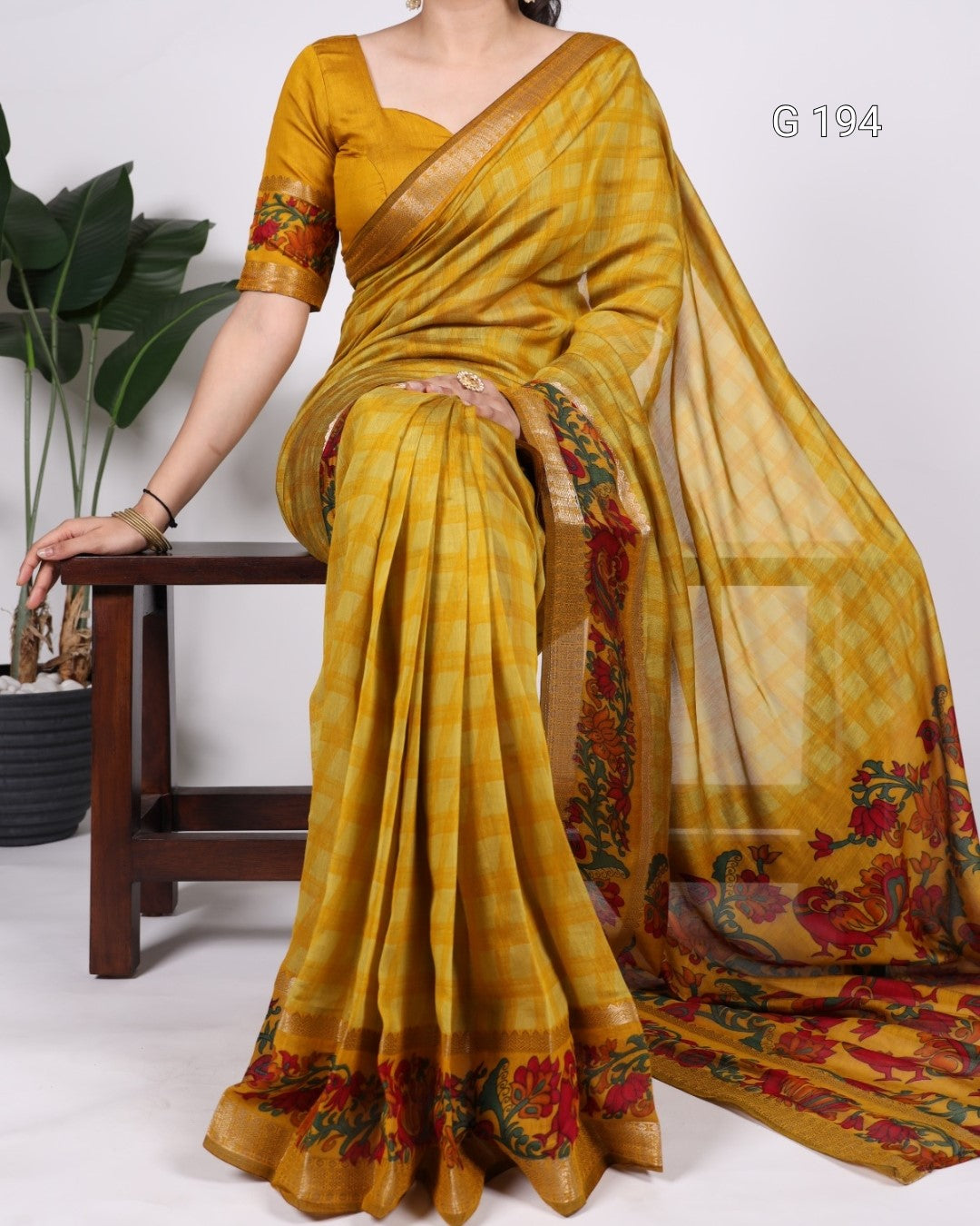 Yellow saree with floral patterns on a white background