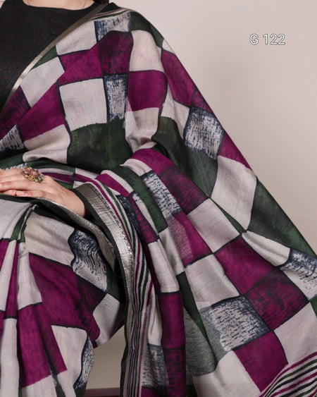 Saree with a geometric pattern draped over a person, on a plain background