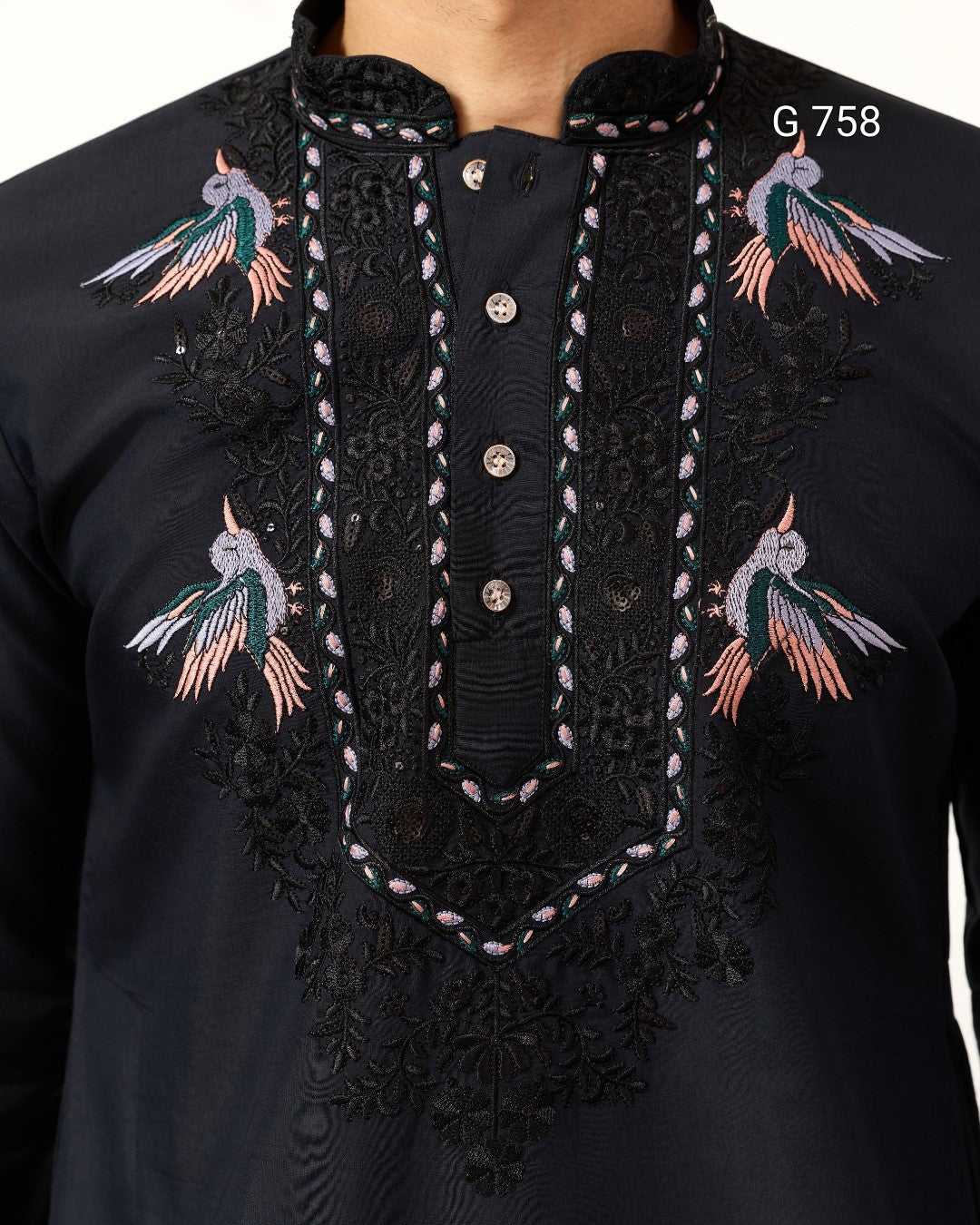 Navy Blue embroidered garment with bird designs on a white background