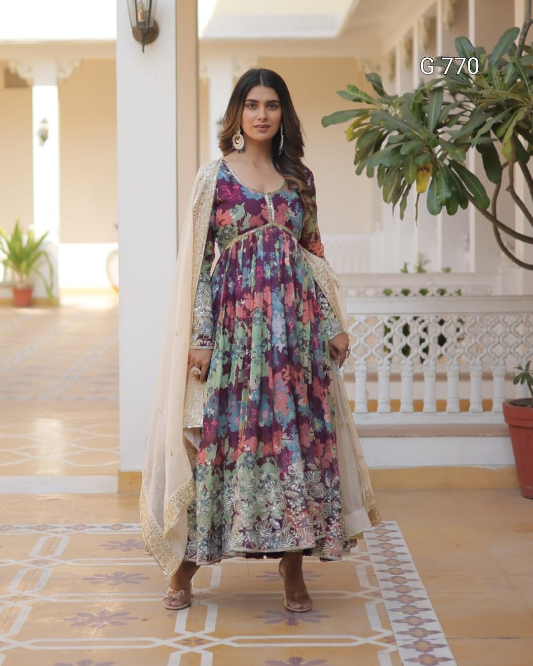 Woman in a floral dress standing in a decorated indoor setting