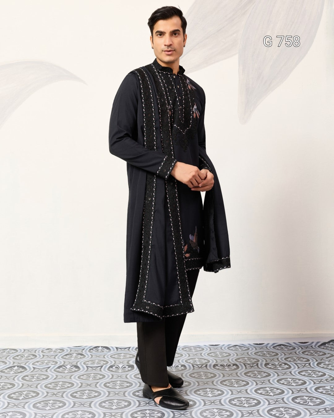 Man wearing a Navy Blue embroidered kurta with pants on a white background