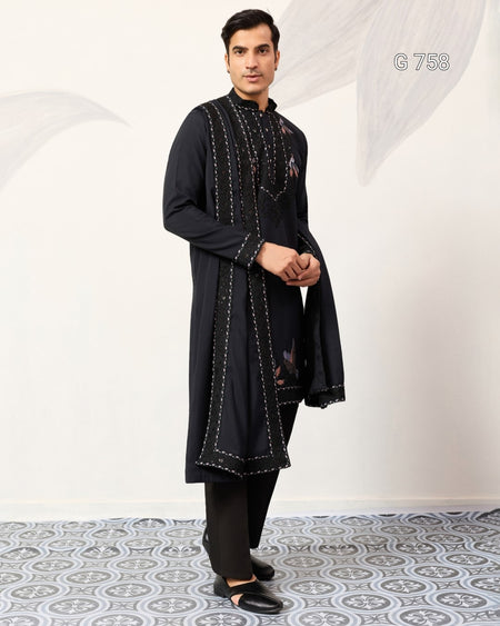 Man wearing a Navy Blue embroidered kurta with pants on a white background