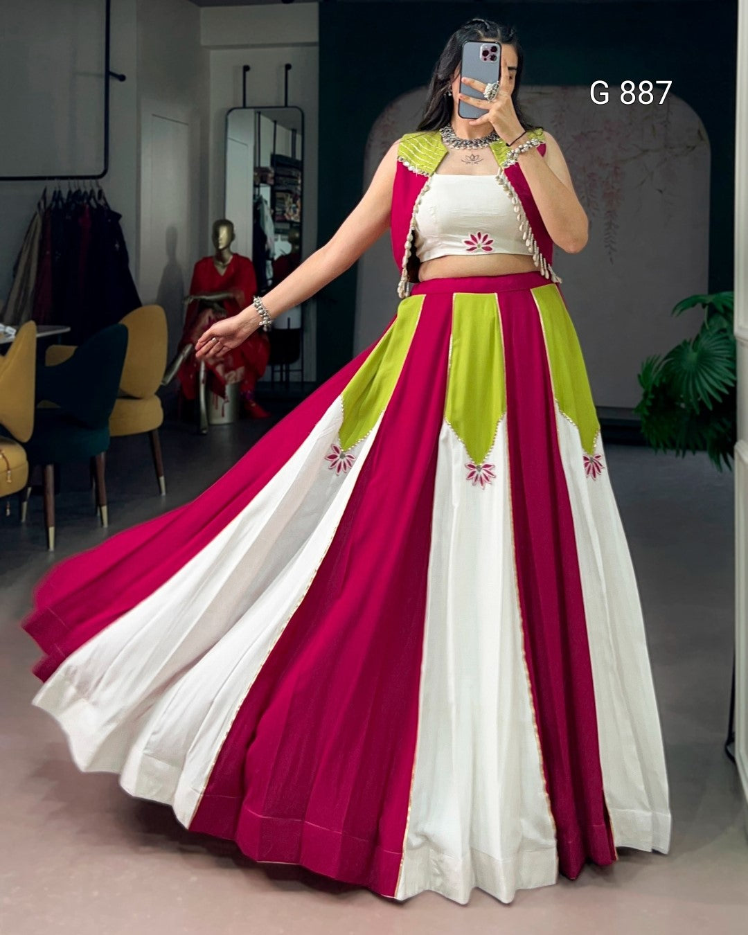 Woman wearing a colorful traditional outfit with a long skirt in a room.