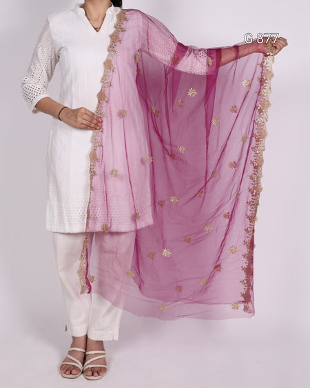 Person wearing a white outfit with a pink dupatta featuring gold embroidery on a plain background
