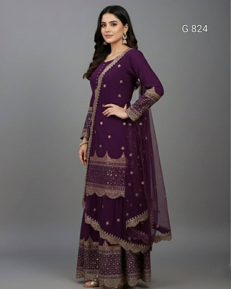 Woman wearing a purple traditional outfit with intricate designs on a gray background