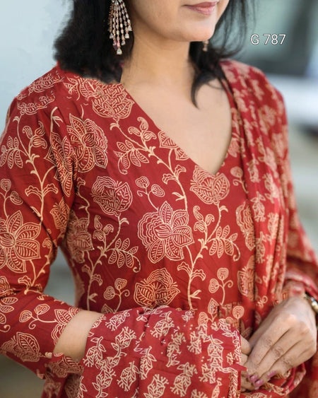 Woman wearing a red floral patterned outfit with a blurred background