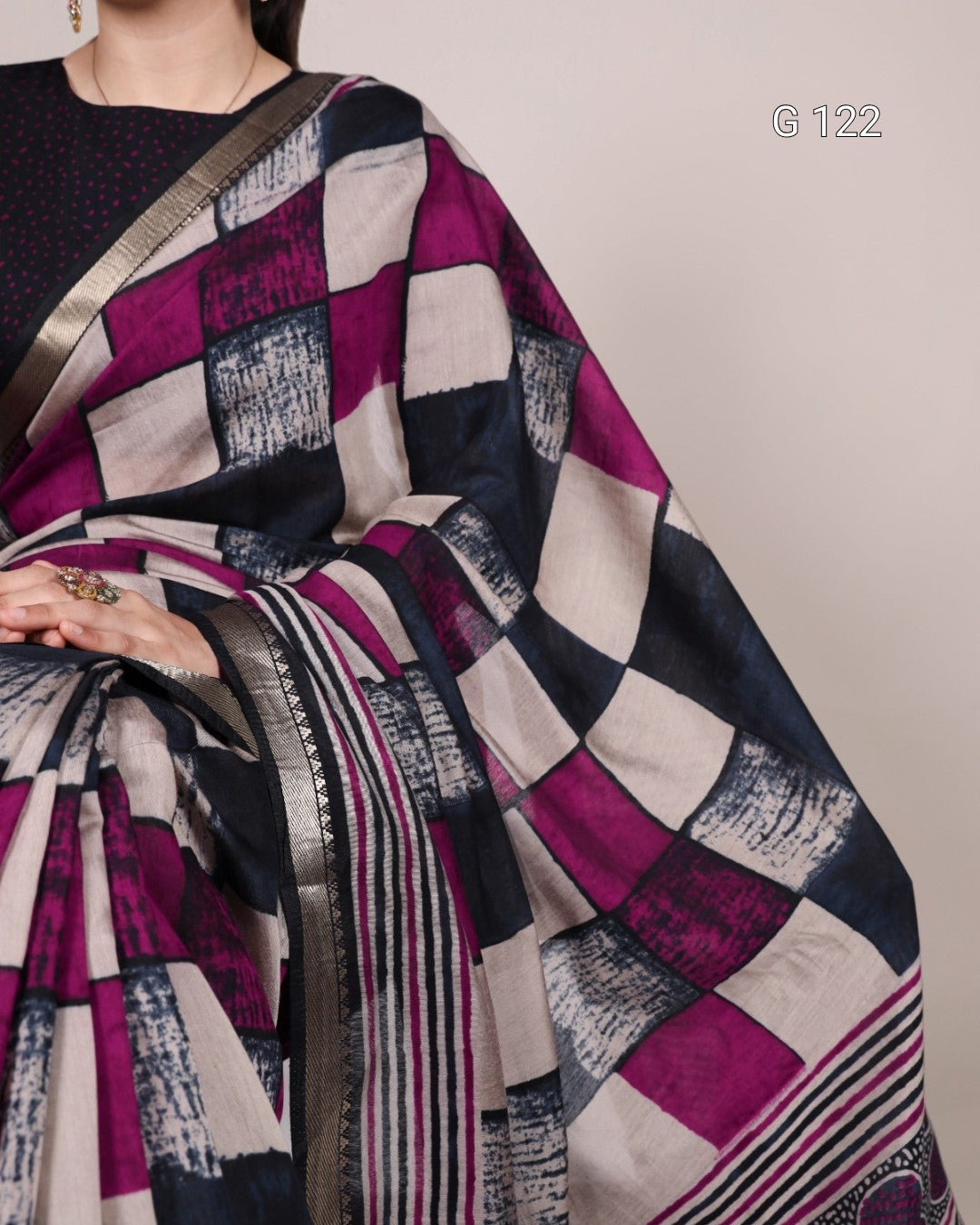Saree with a geometric pattern draped over a person against a neutral background