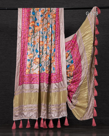 Colorful saree with floral patterns and tassels on a dark background