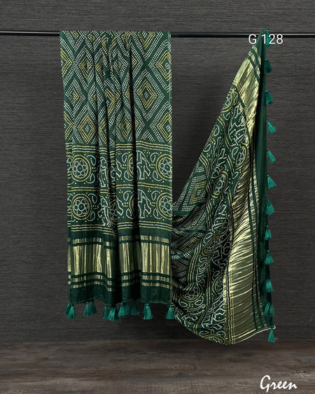 Green patterned scarf with tassels on a dark background