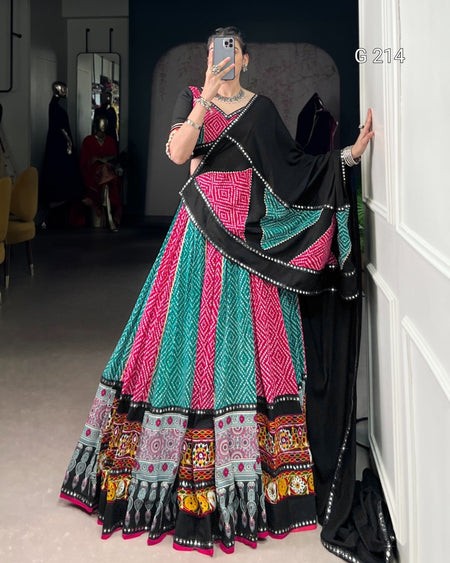 Person wearing a colorful traditional outfit with patterns in a room.