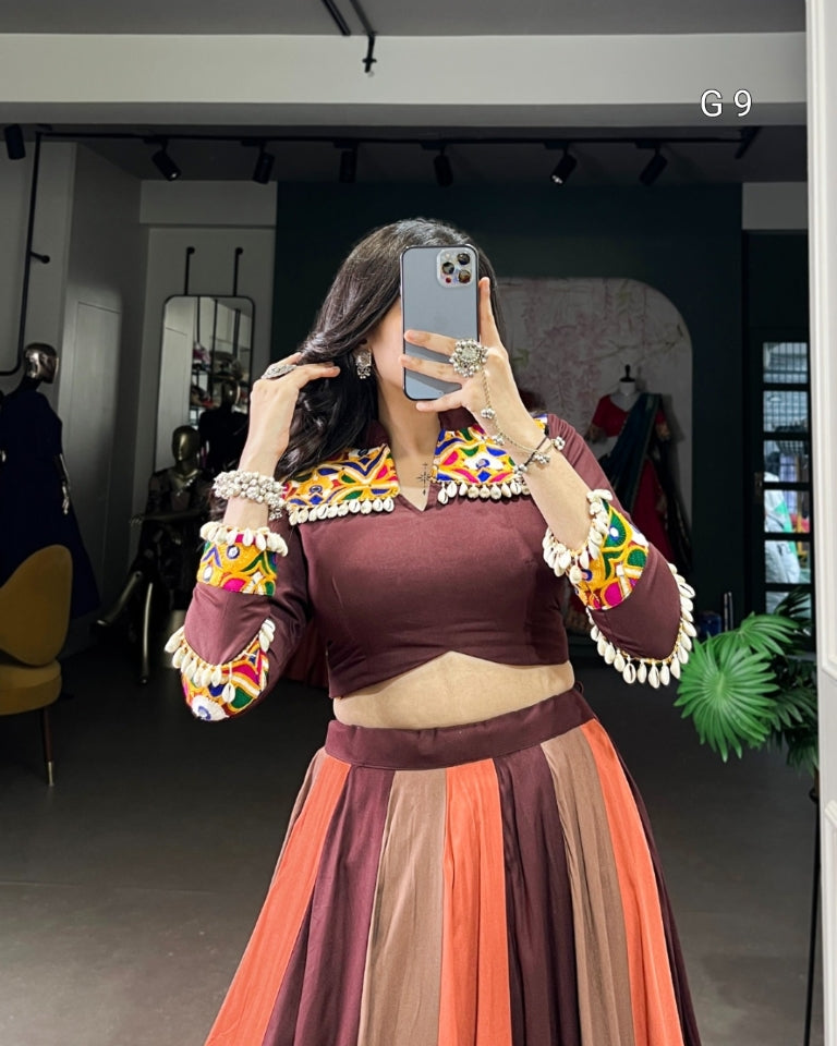 Woman taking a mirror selfie wearing a traditional outfit with colorful embroidery.