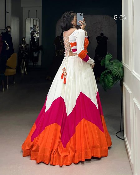 Woman taking a selfie wearing a colorful dress with a geometric pattern.