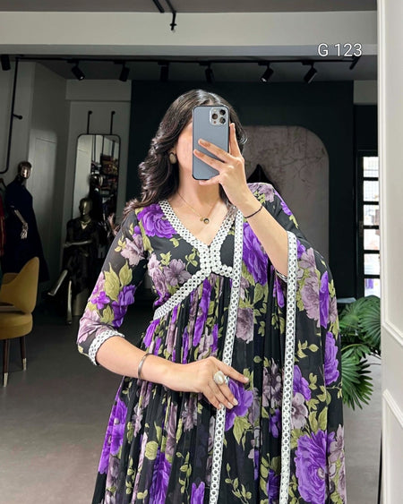 Woman taking a mirror selfie wearing a floral dress with a long white scarf.