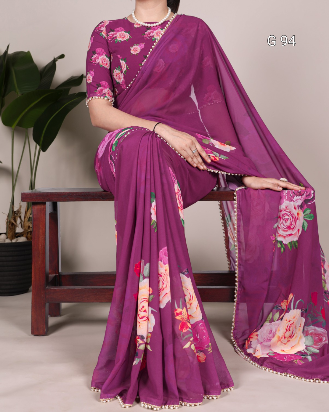 Purple saree with floral patterns on a plain background