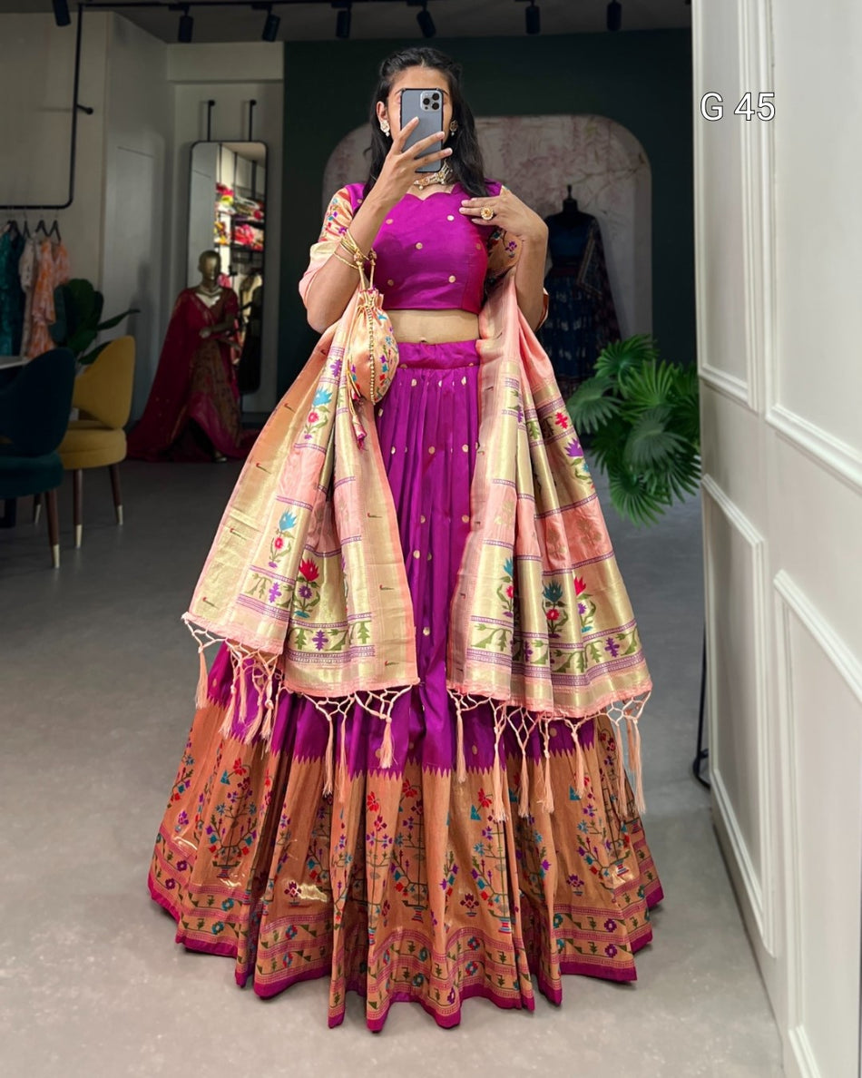 Woman taking a mirror selfie wearing a traditional outfit with a colorful dupatta.