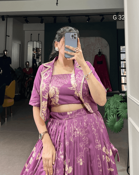 Person wearing a purple traditional outfit with gold patterns in a store setting.