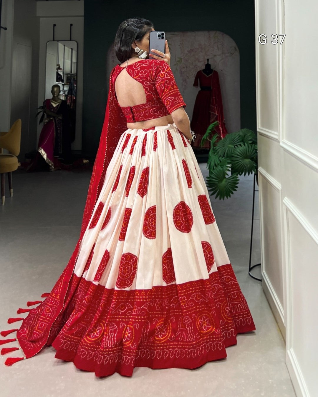 Woman wearing a red and white traditional outfit in a room.