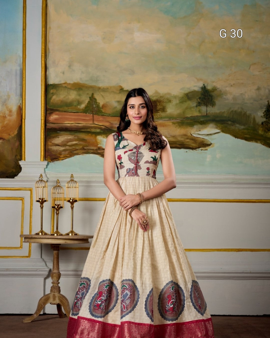 Woman in a patterned dress standing in a room with a large painting on the wall.