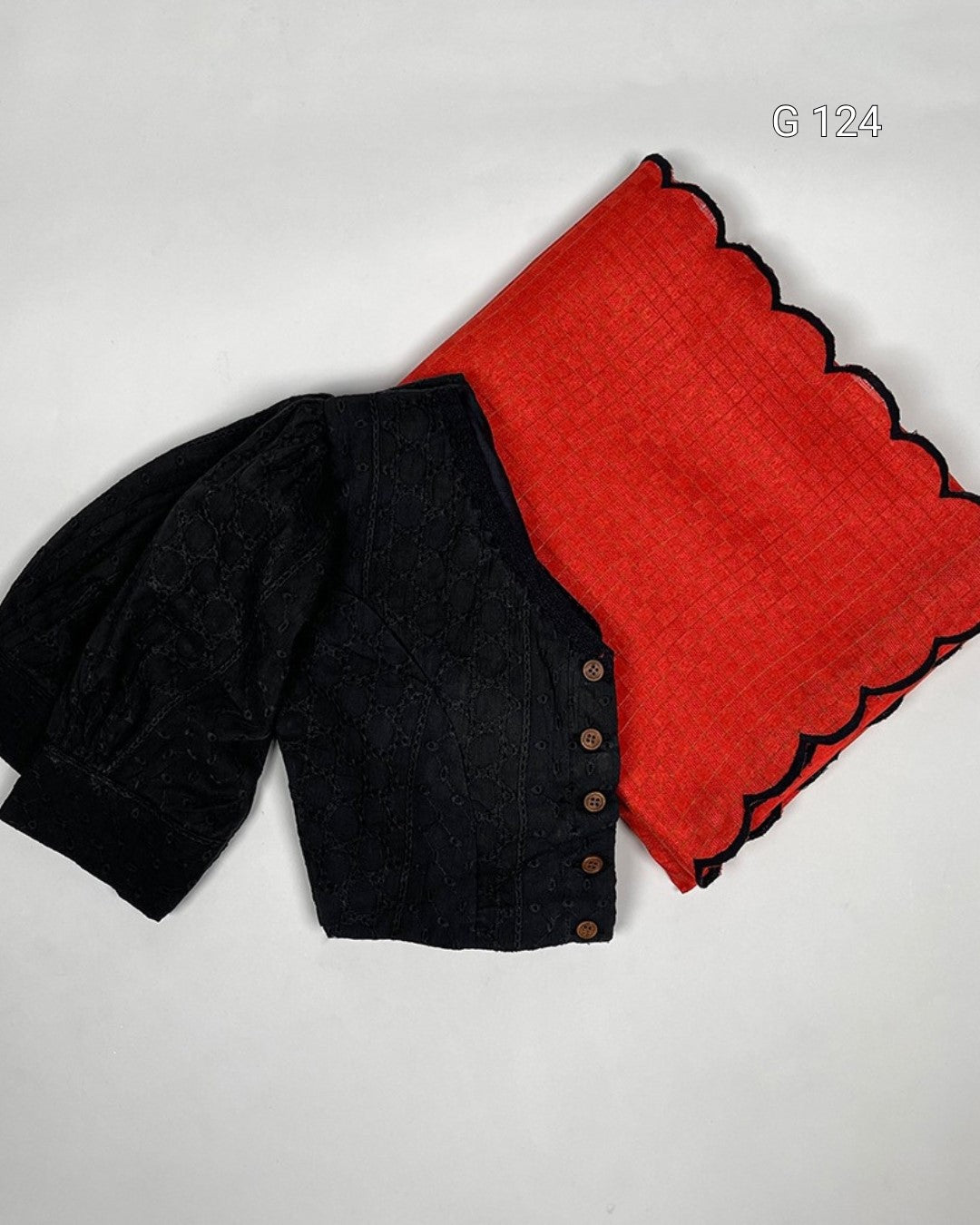 Black cardigan with red fabric on a light gray background