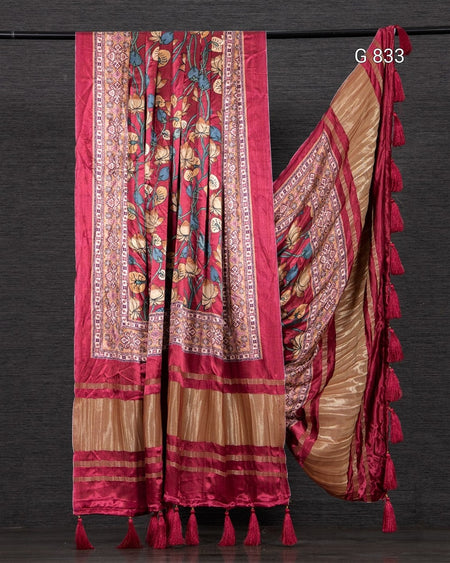 Colorful saree with intricate patterns on a dark background