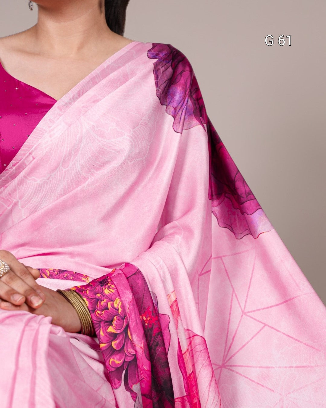 Pink saree with purple and pink floral patterns on a neutral background