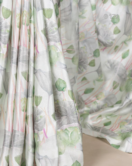Sheer fabric with floral pattern in green and pink on a white background
