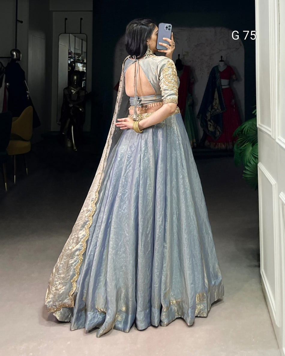Woman in a traditional outfit taking a mirror selfie in a clothing store.