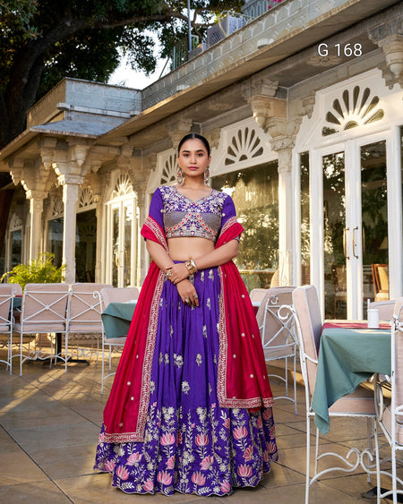 Woman in a traditional outfit standing outdoors with a building in the background