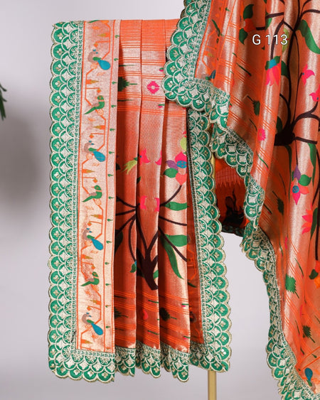 Orange fabric with green border and floral patterns on a white background