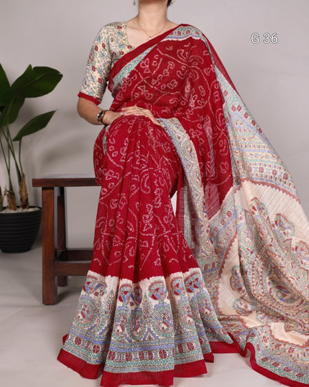 Red and white patterned saree with a wooden stool and plant in the background