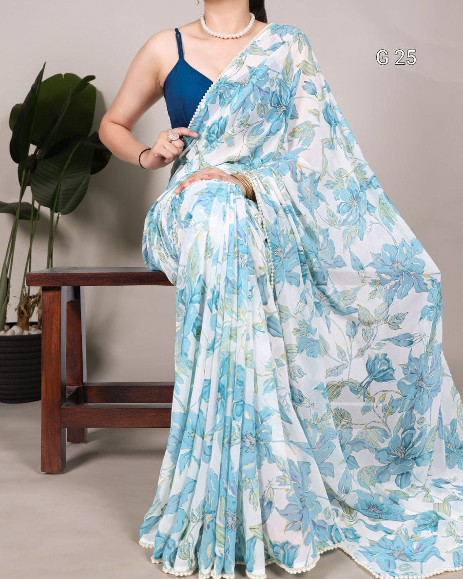 Woman wearing a blue floral saree with a plain background