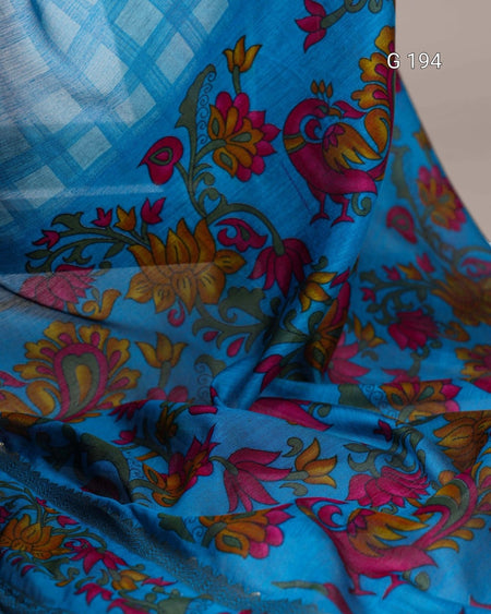 Colorful floral and peacock pattern on a blue fabric background