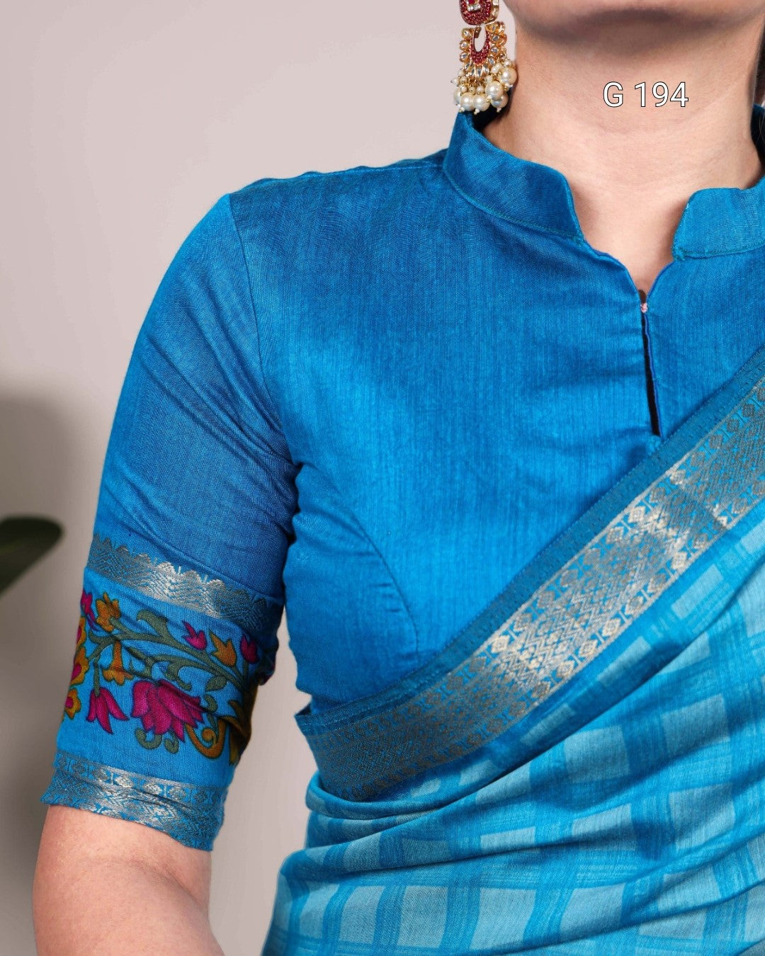 Blue saree with intricate patterns on a plain background