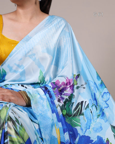 Woman wearing a blue floral saree with a plain background