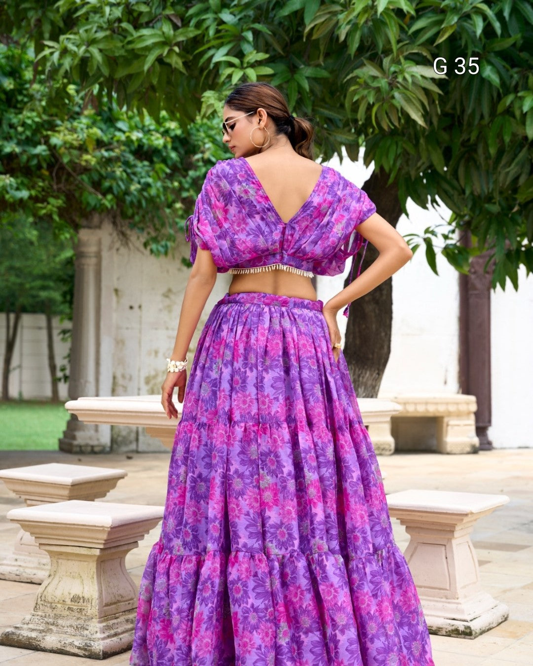 Woman wearing a purple floral dress in an outdoor setting