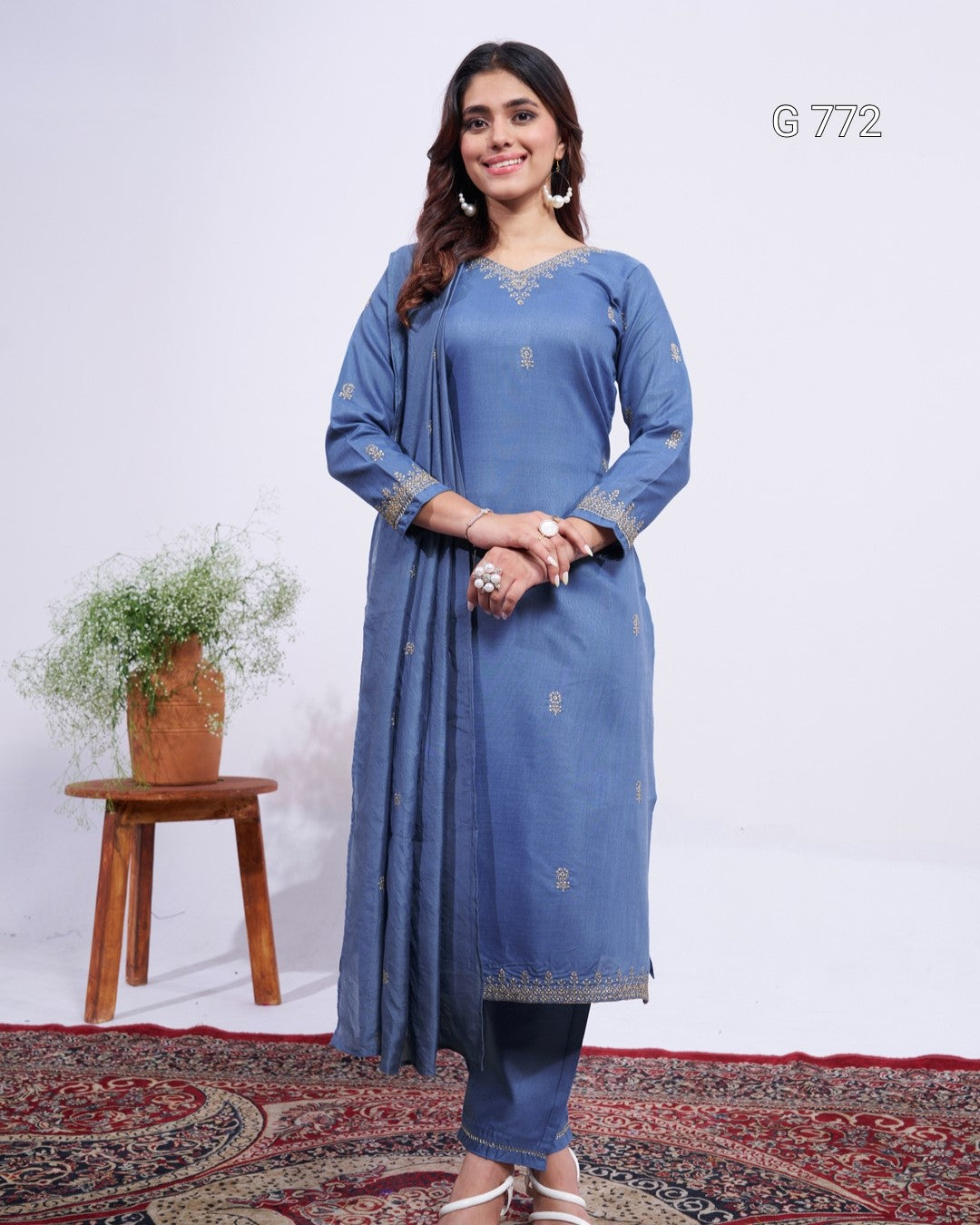 Woman wearing a blue traditional outfit with a white background