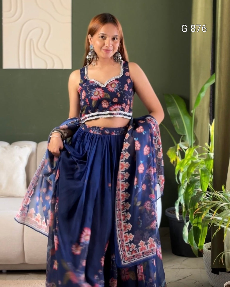 Woman wearing a blue floral saree with a matching blouse in a room setting.