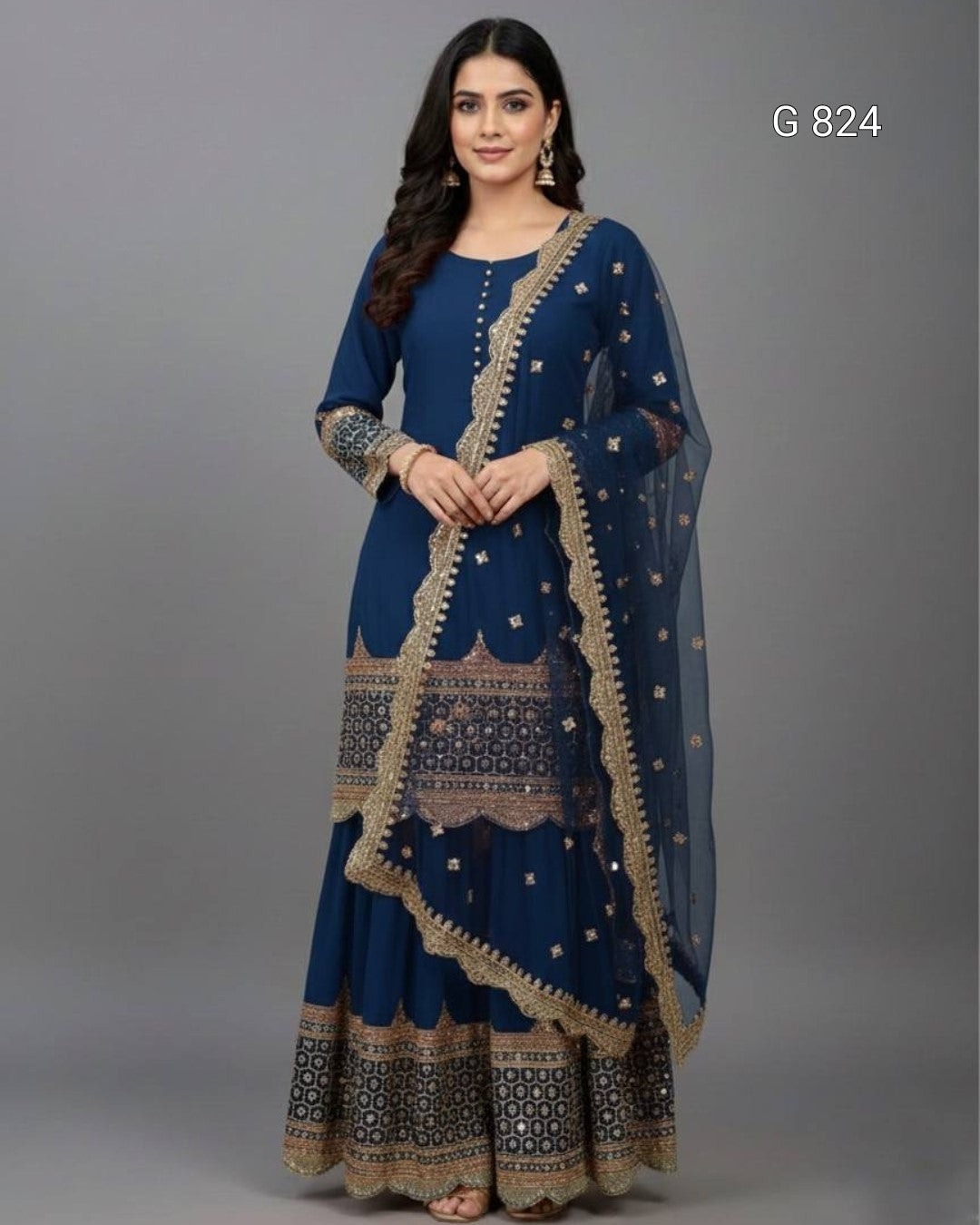 Woman wearing a blue traditional outfit with intricate patterns on a gray background