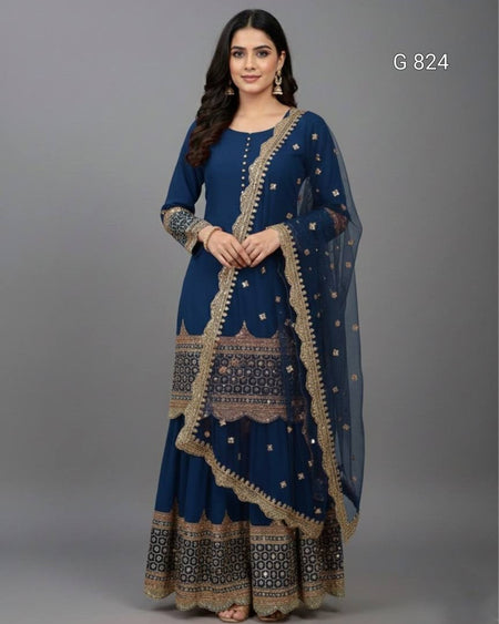 Woman wearing a blue traditional outfit with intricate patterns on a gray background