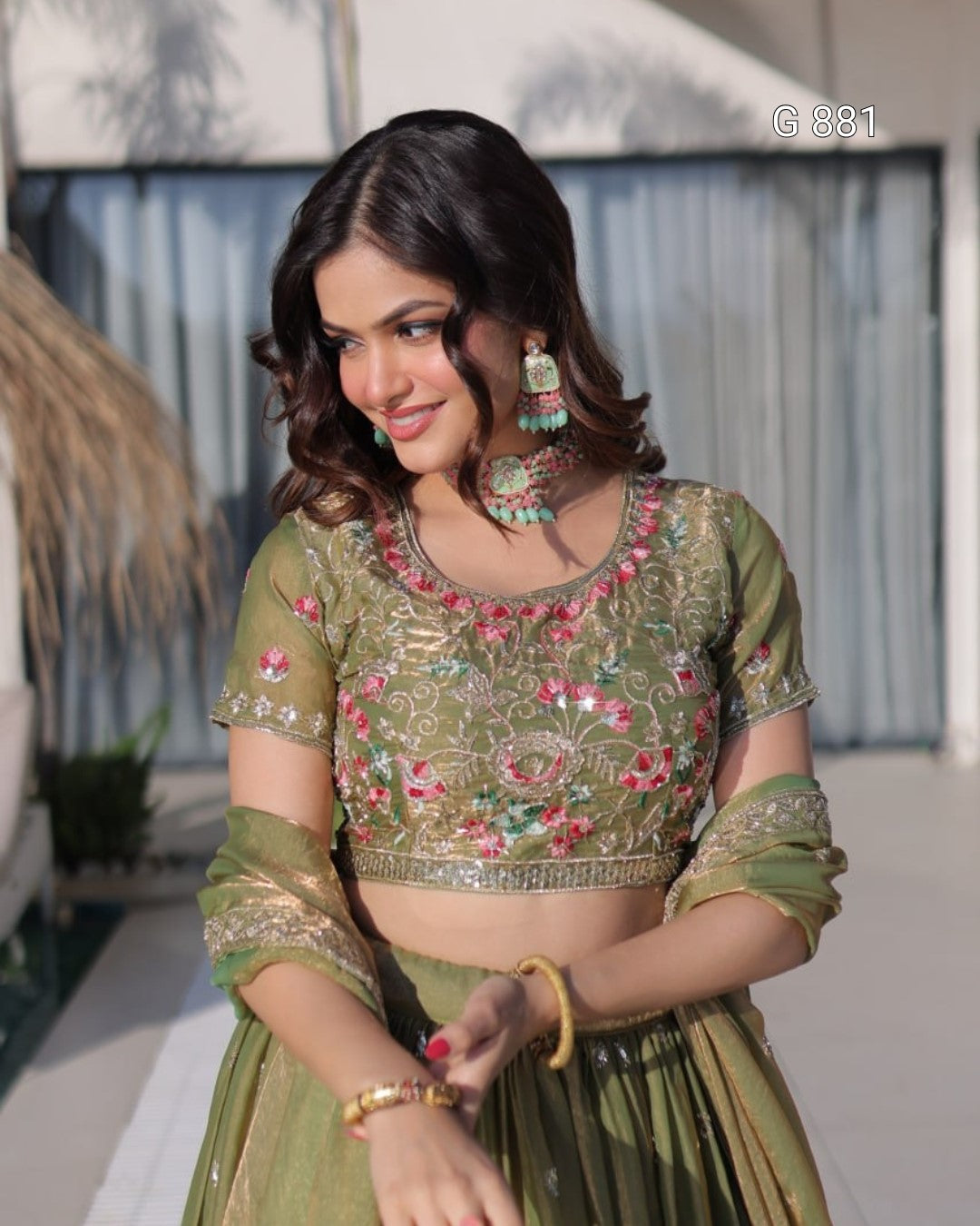 Woman wearing a green embroidered traditional outfit with a blurred background