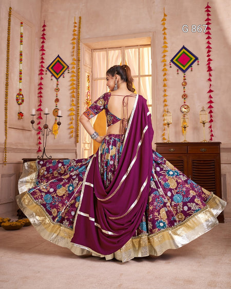 Woman in a colorful saree with a decorative interior background