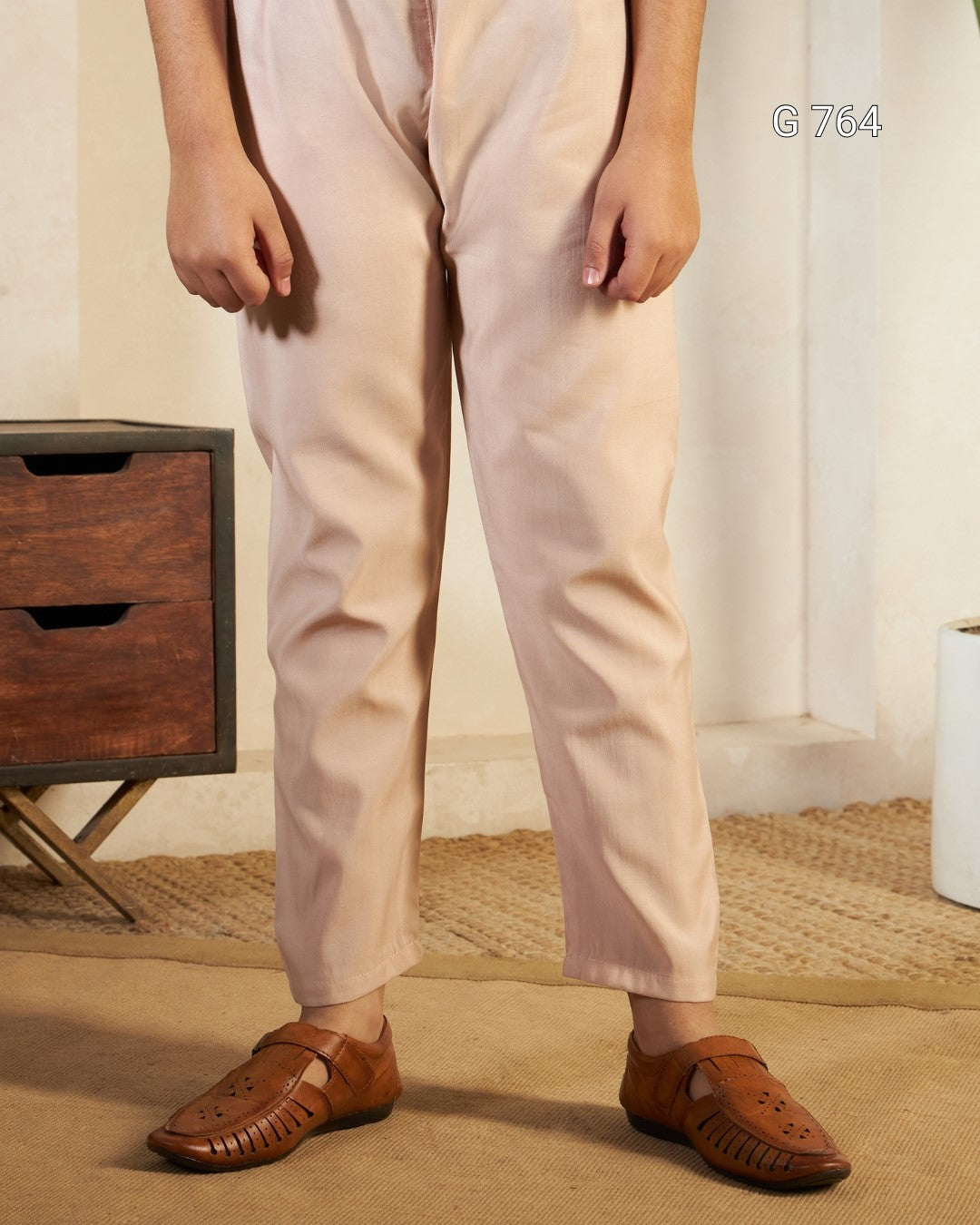 Person wearing beige pants and brown shoes in a room with wooden furniture and a white curtain.