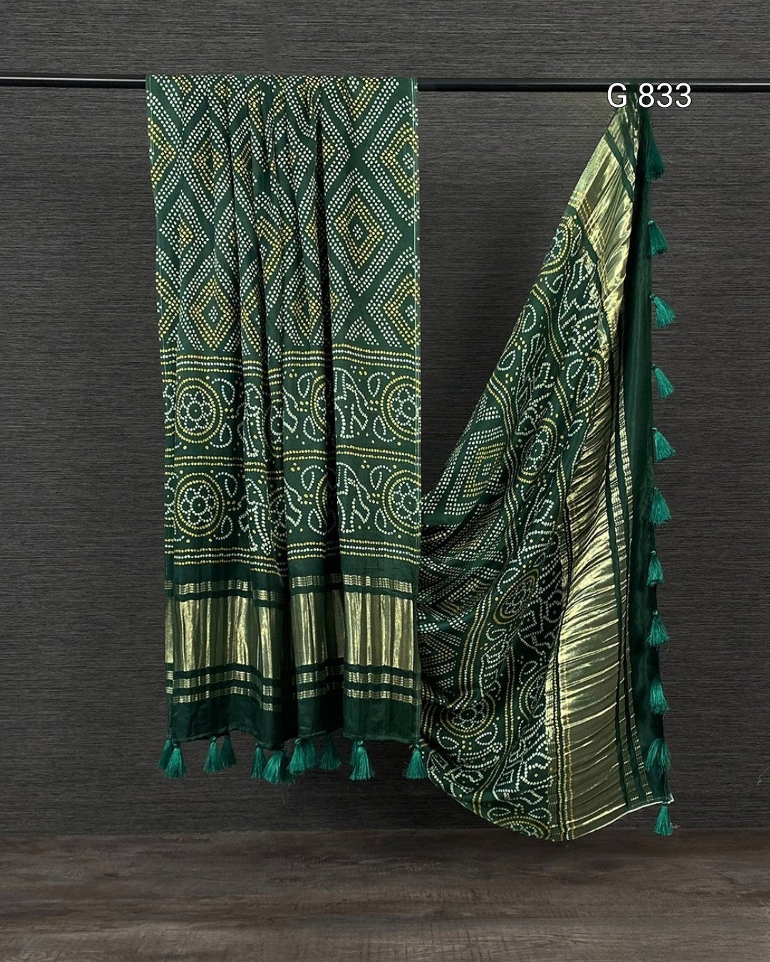 Green patterned scarf with tassels on a dark wooden background